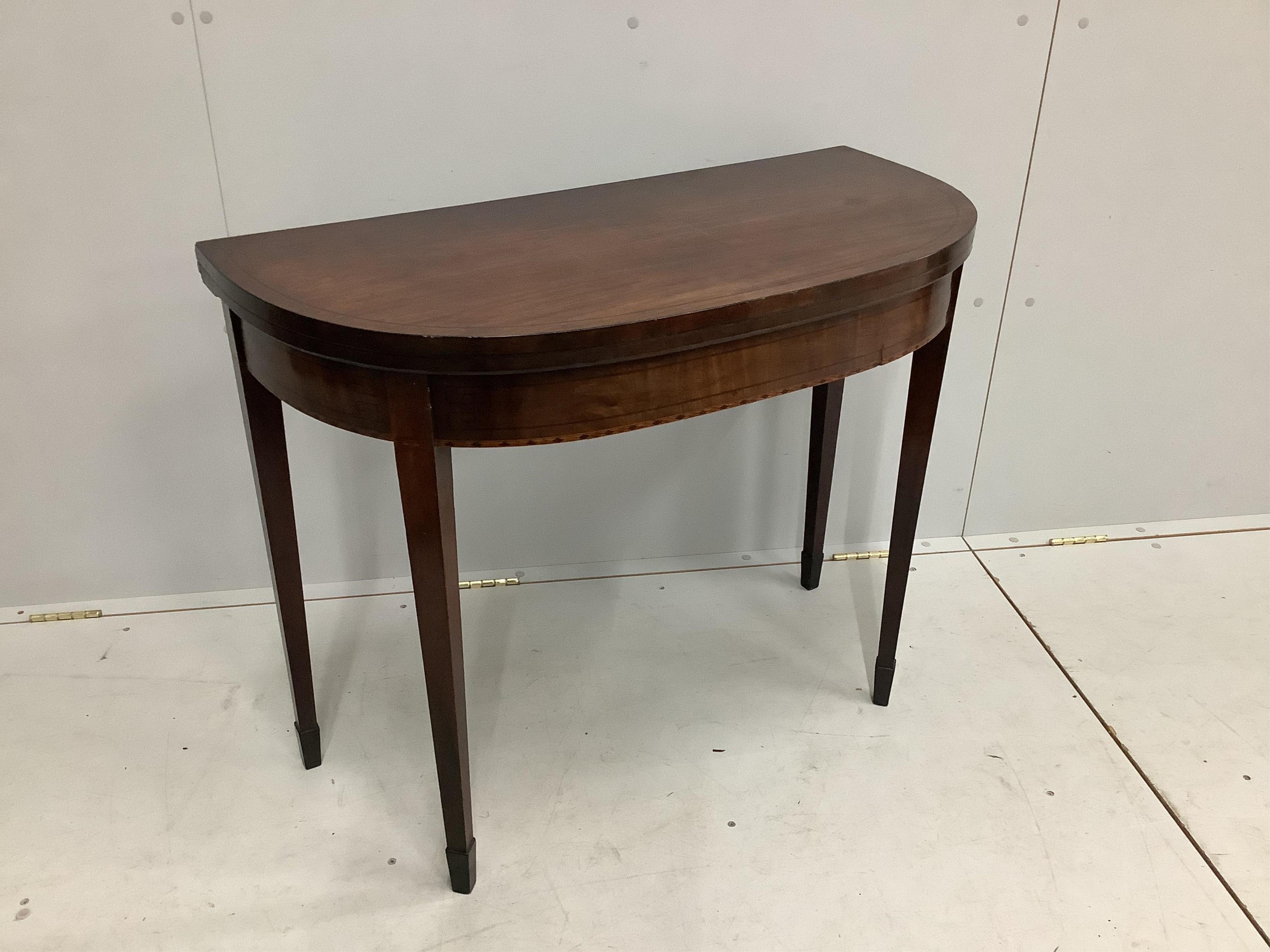 A Regency ebony strung mahogany folding tea table, width 92cm, height 74cm. Condition - fair to good